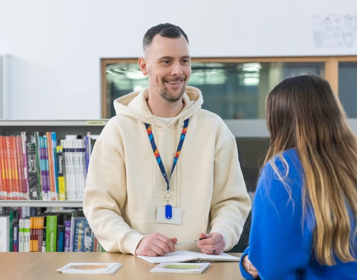 Student receiving support from a staff advisor at a desk in the Glasgow Kelvin College library. Student receiving support from a staff advisor at a desk in the Glasgow Kelvin College library.